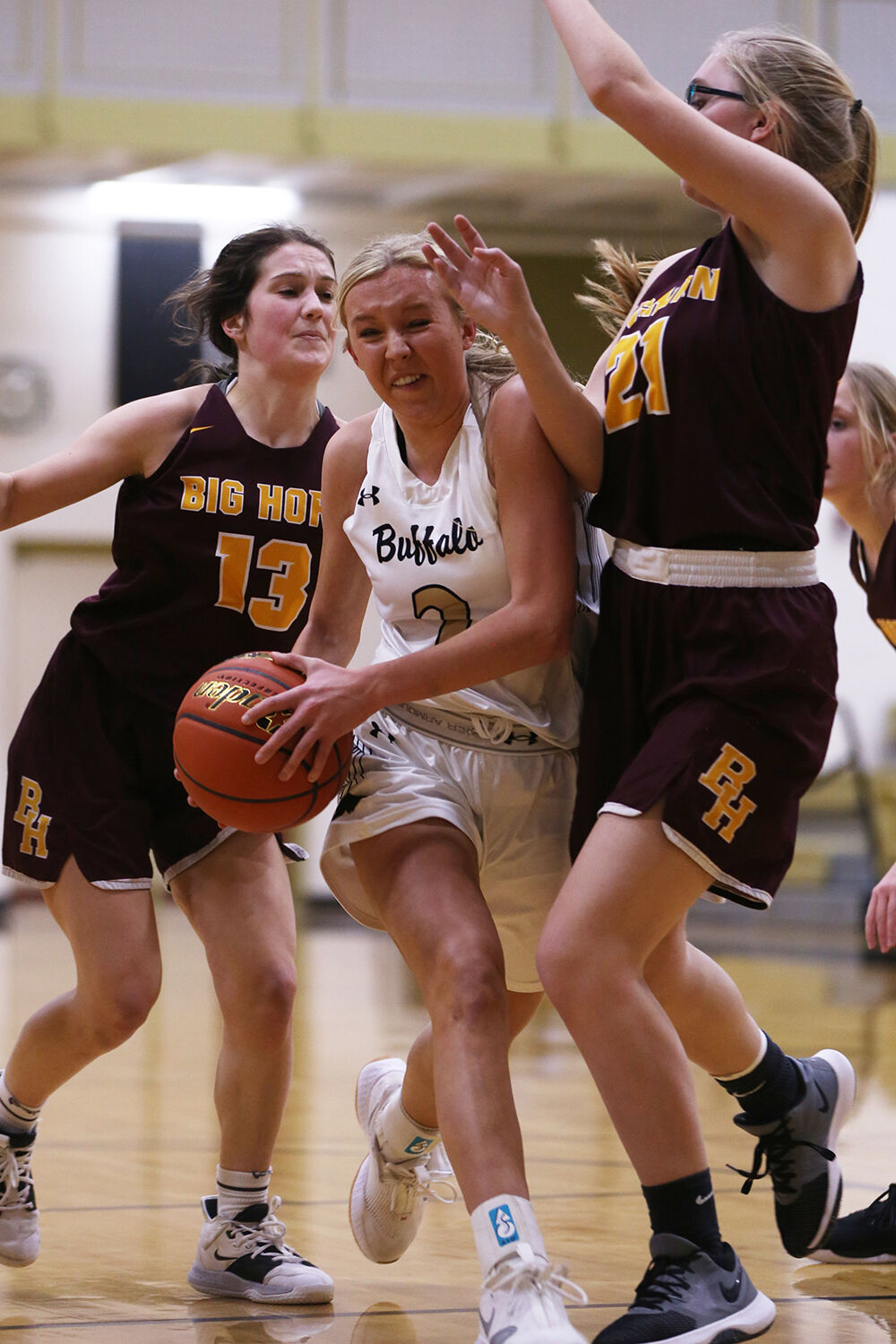 Kendall Tietjen pushes through Big Horn junior Kylee Lamb on her way to the basket